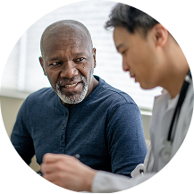 Patient listening to healthcare professional during consultation in clinic.