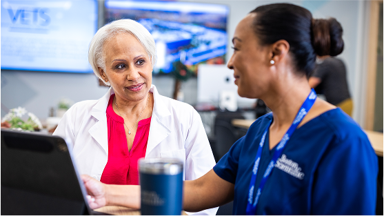 Boston Scientific rep talks with physician in office setting.